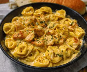 Delicious Cajun Garlic Chicken Tortellini in creamy three-cheese sauce served on a plate