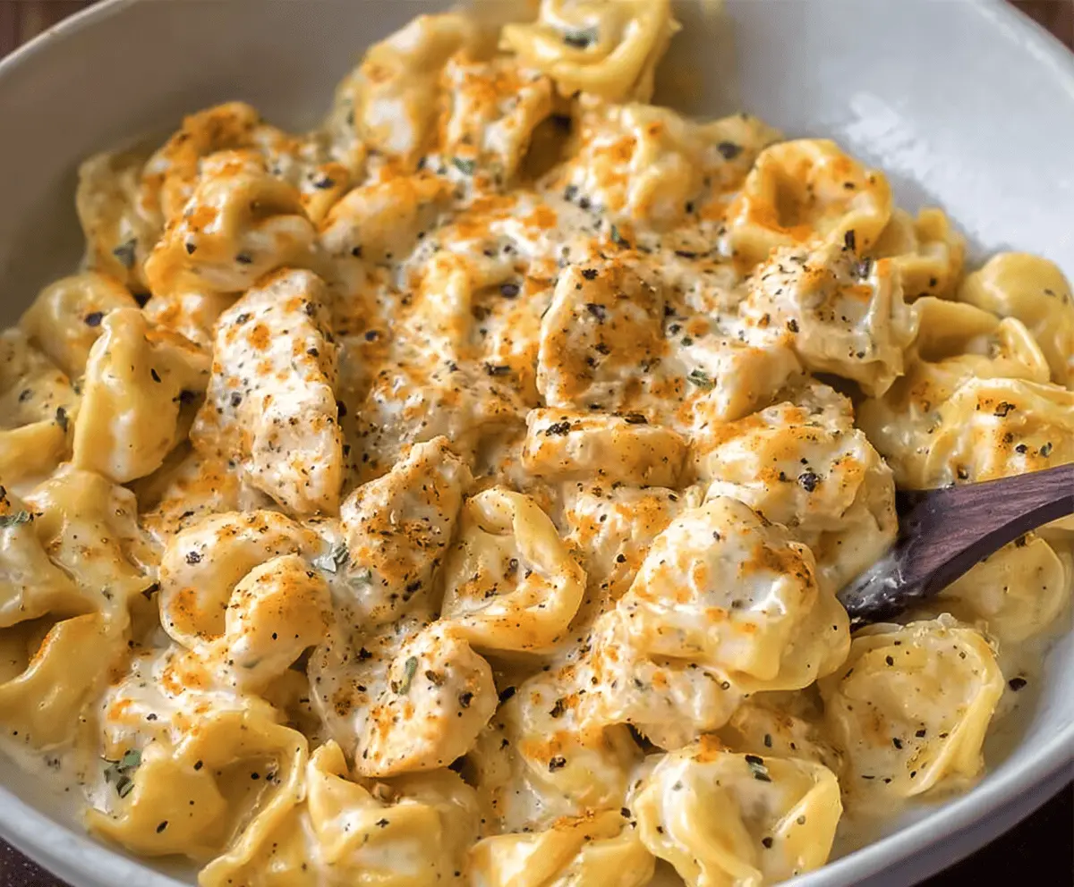 Creamy Garlic Parmesan Chicken Tortellini dish with tender chicken, flavorful tortellini, and fresh herbs garnished for serving