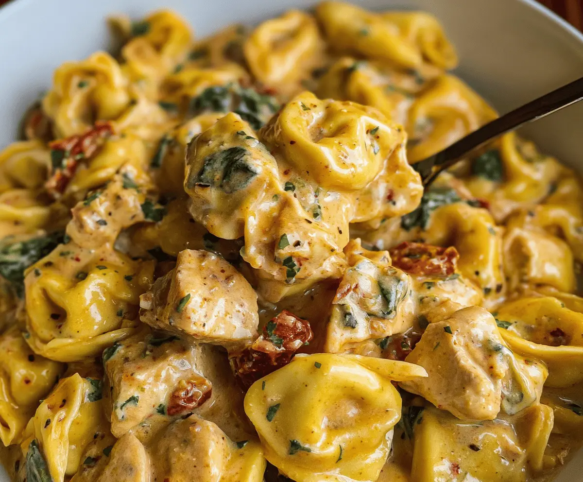 Creamy Marry Me Chicken Tortellini served in a bowl topped with fresh herbs and grated cheese, showcasing a delicious and hearty pasta dish perfect for dinner