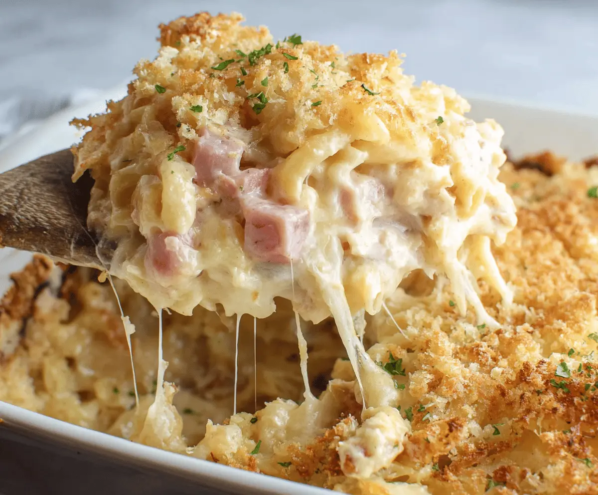 Delicious Chicken Cordon Bleu Casserole topped with melted cheese and crispy golden breadcrumbs, served in a baking dish.
