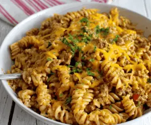 Creamy cheesy ground turkey pasta served on a plate, topped with melted cheese and fresh herbs, showcasing a delicious and comforting meal perfect for quick dinner ideas.