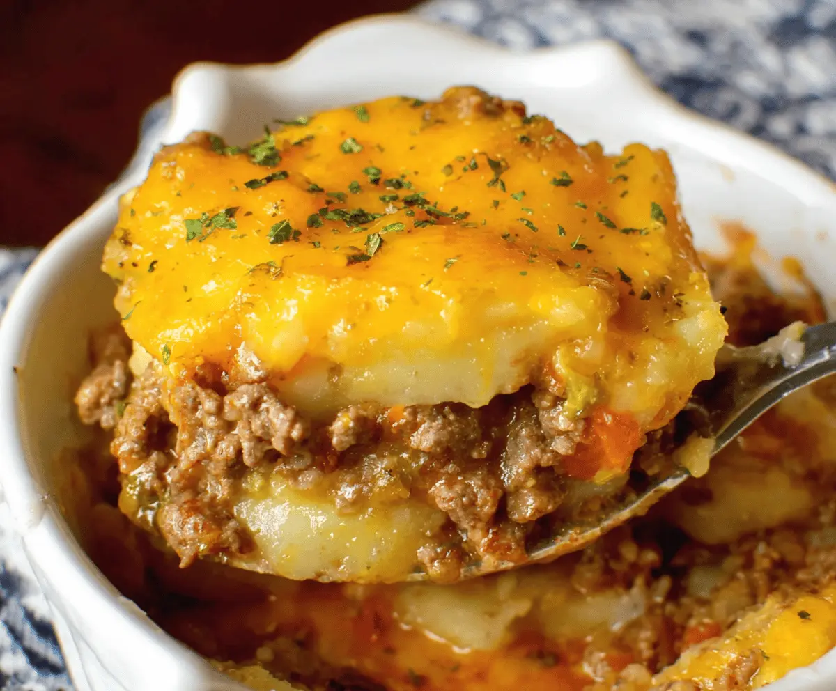 Hearty ground beef and potatoes casserole served in a baking dish with melted cheese, perfect for a comforting family dinner