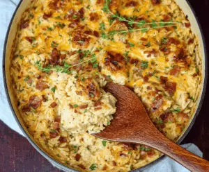 Creamy French Onion Chicken Orzo Casserole with melted cheese and caramelized onions in a baked dish