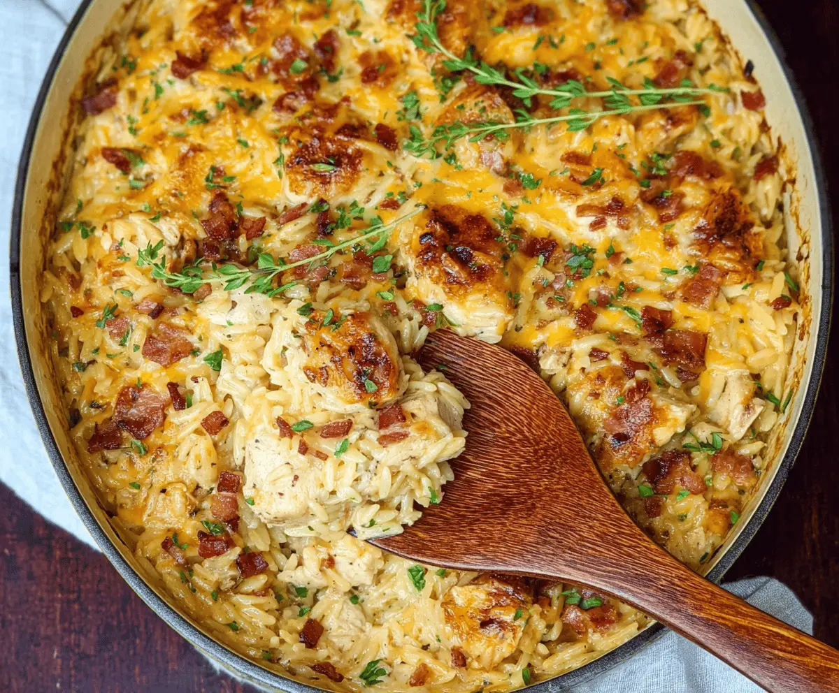 Creamy French Onion Chicken Orzo Casserole with melted cheese and caramelized onions in a baked dish