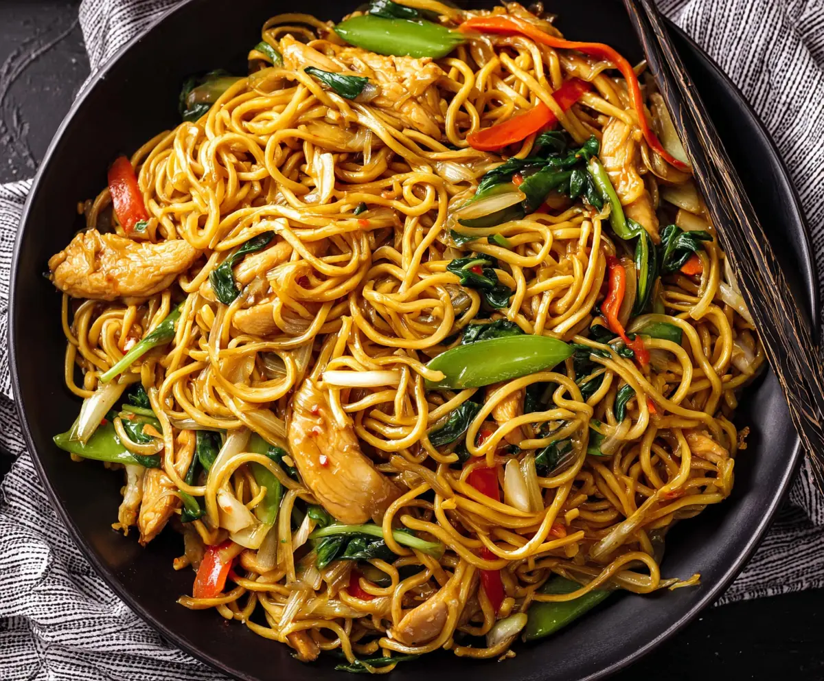 Delicious Chicken Chow Mein with stir-fried vegetables and tender chicken strips on a plate.