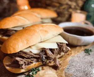 Delicious Crock Pot French Dip Sandwiches with tender roast beef and melted cheese in a crusty baguette