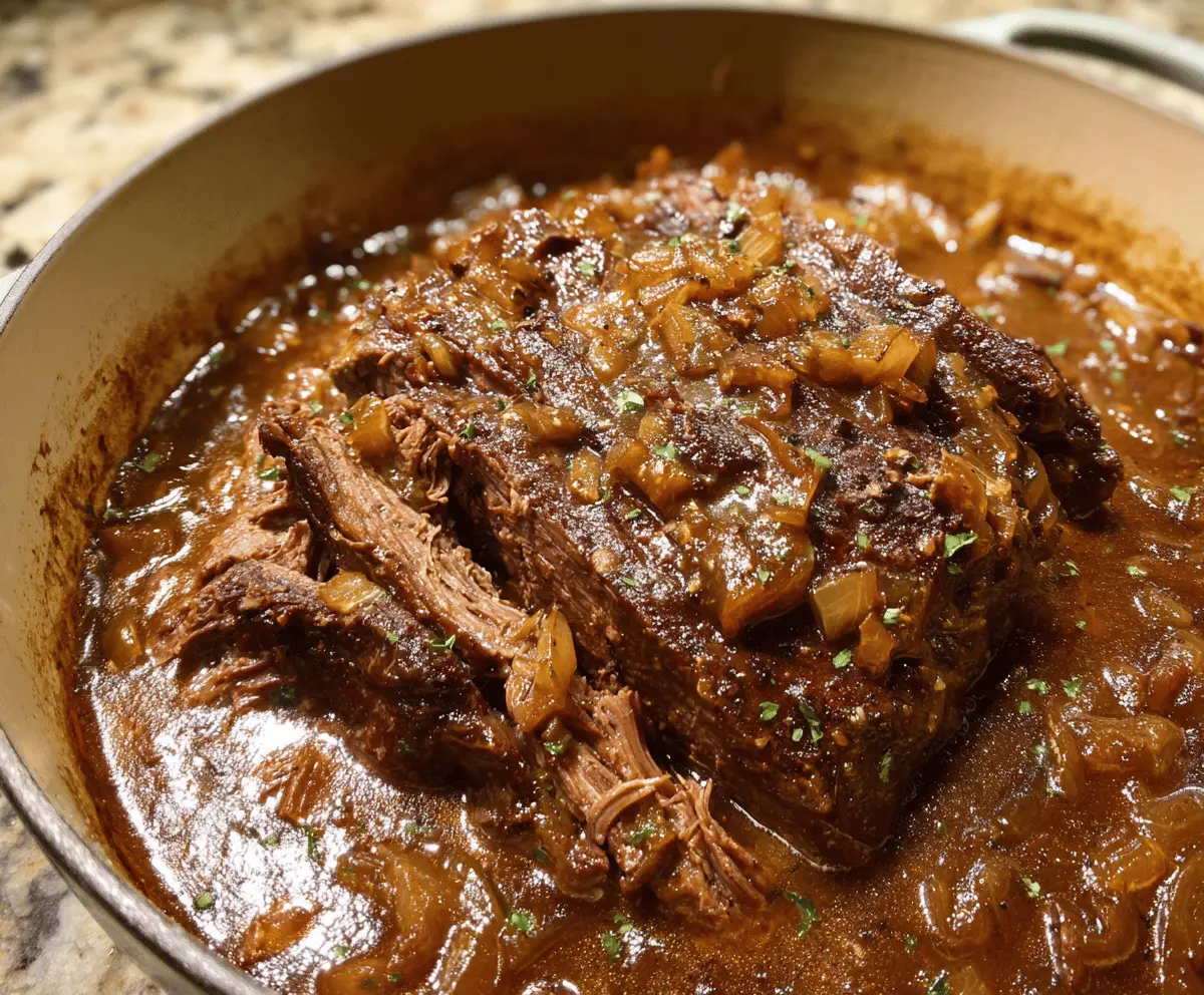 Delicious French onion pot roast with caramelized onions and tender meat served in a rustic dish.