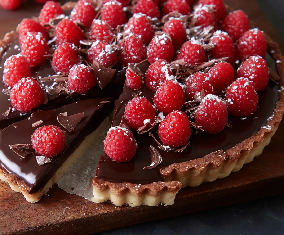 Decadent chocolate raspberry tart, perfect for Valentine's Day desserts, featuring rich chocolate and fresh raspberries.