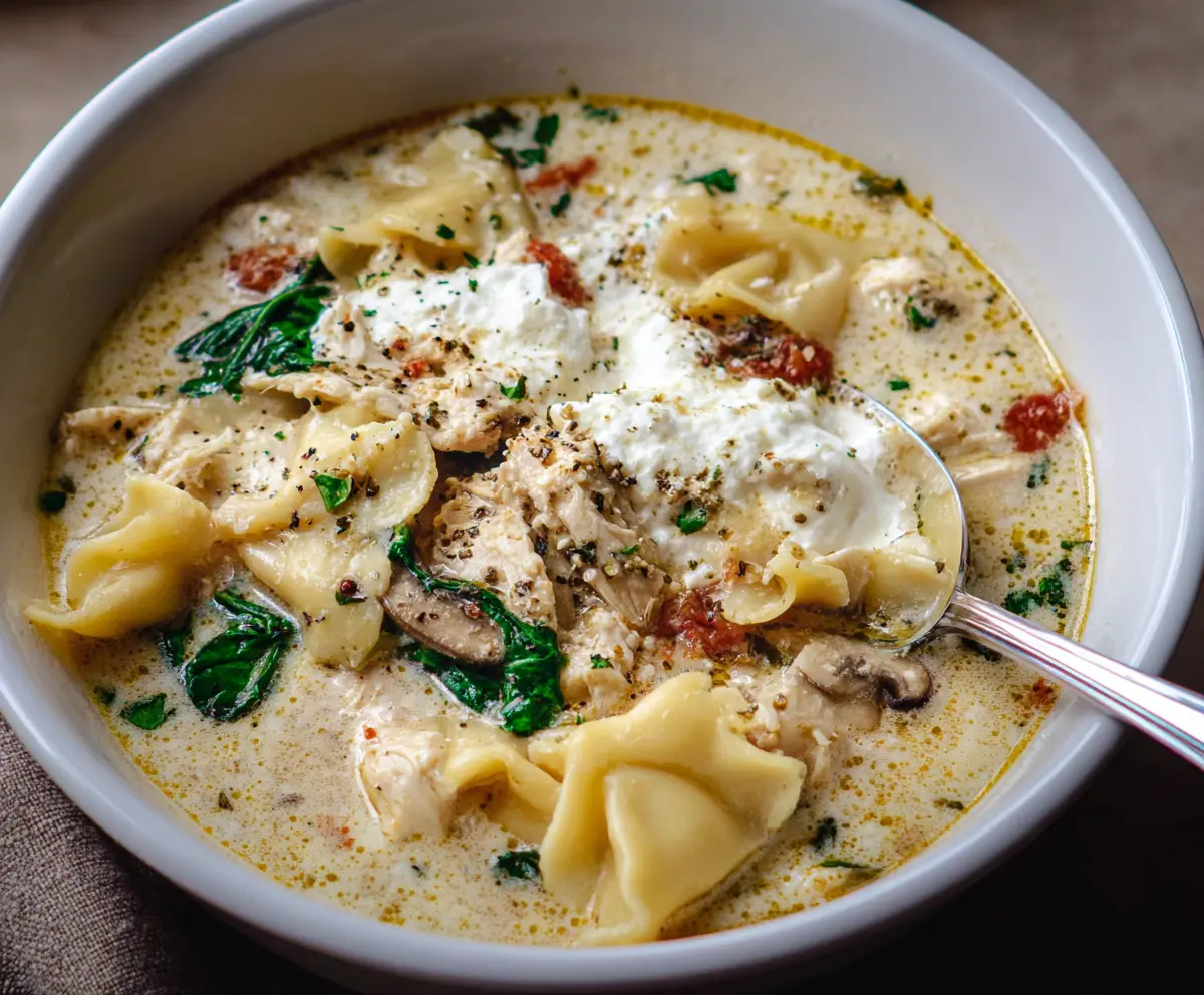 Creamy white lasagna soup garnished with fresh herbs, perfect for a comforting meal.